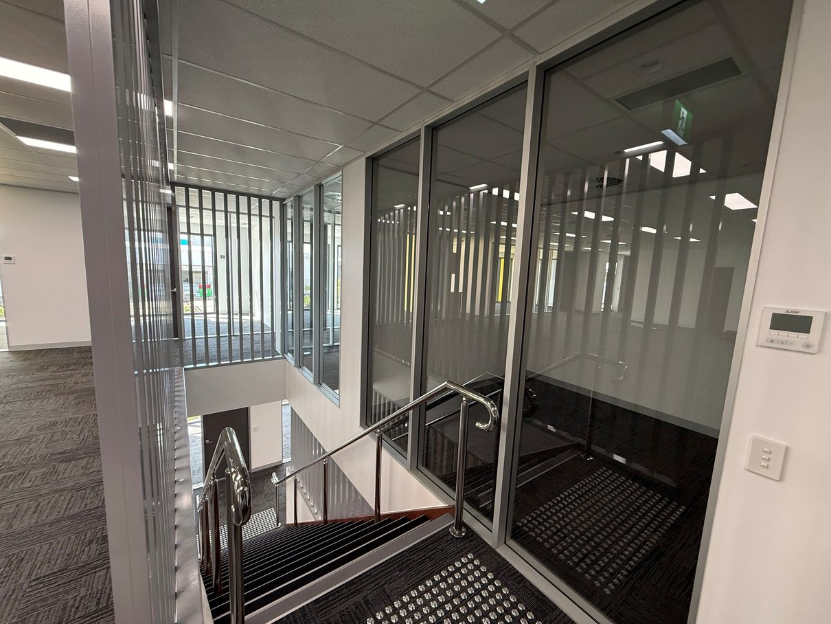 Glazed aluminium office partitions over a stair void