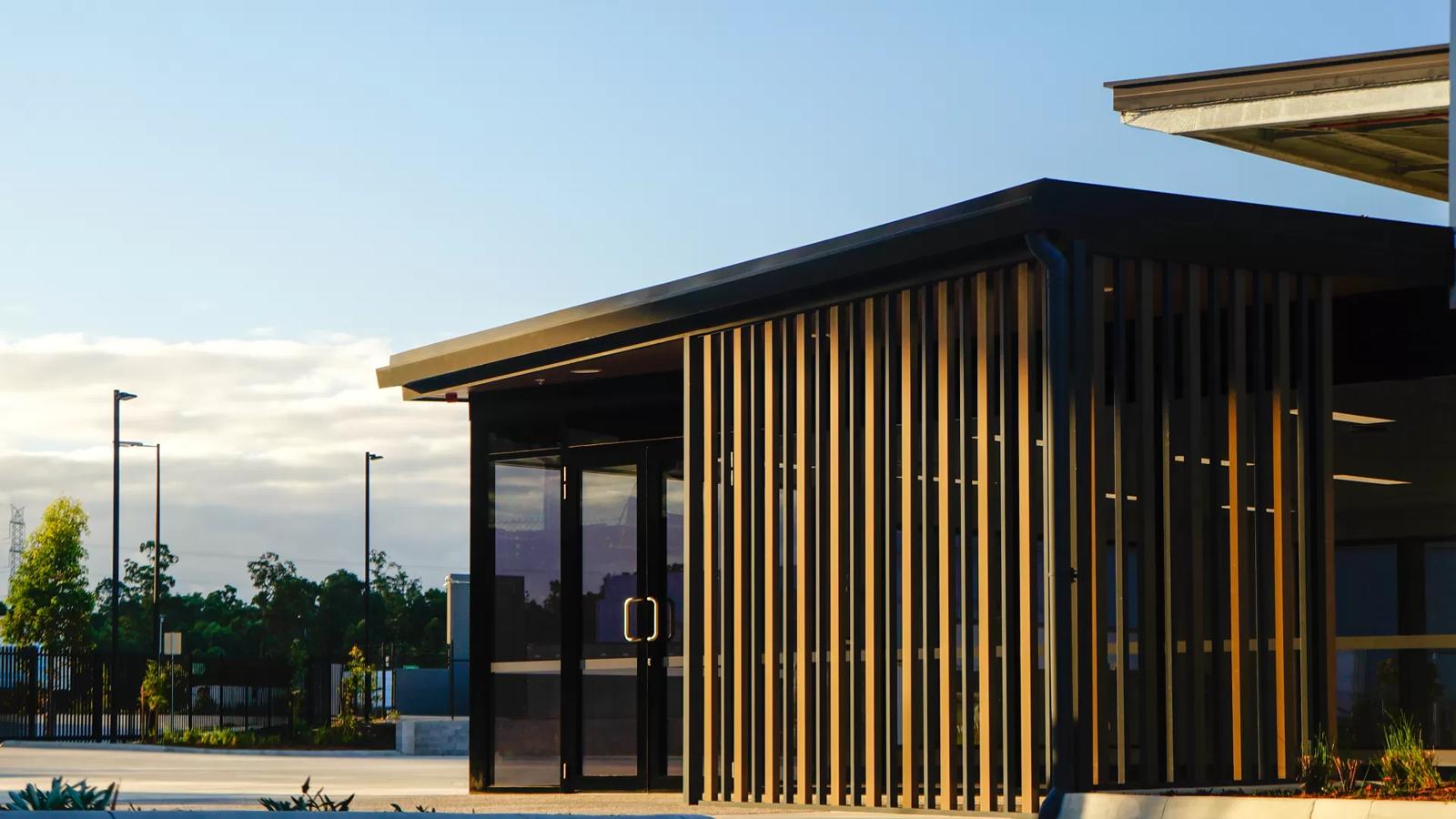 Timber-screened office entry pod at dusk, Seeana Place Heathwood